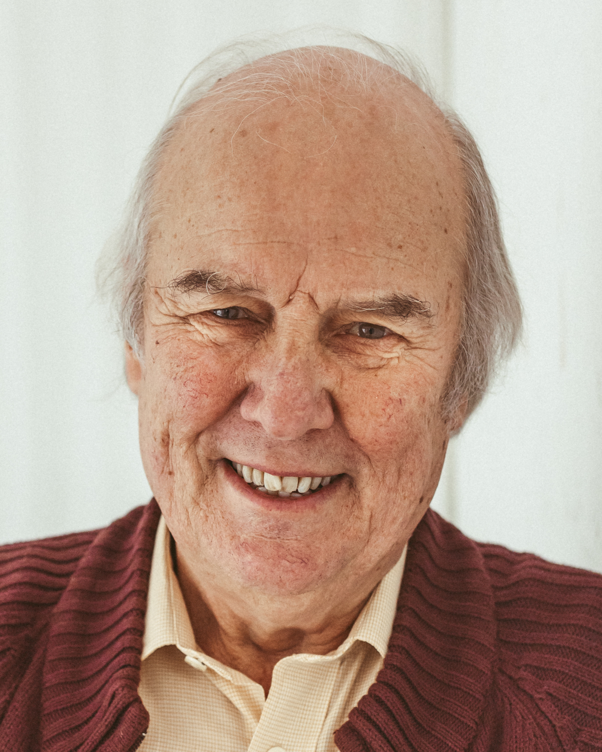 Portrait of white man with medium length hair in his 70's