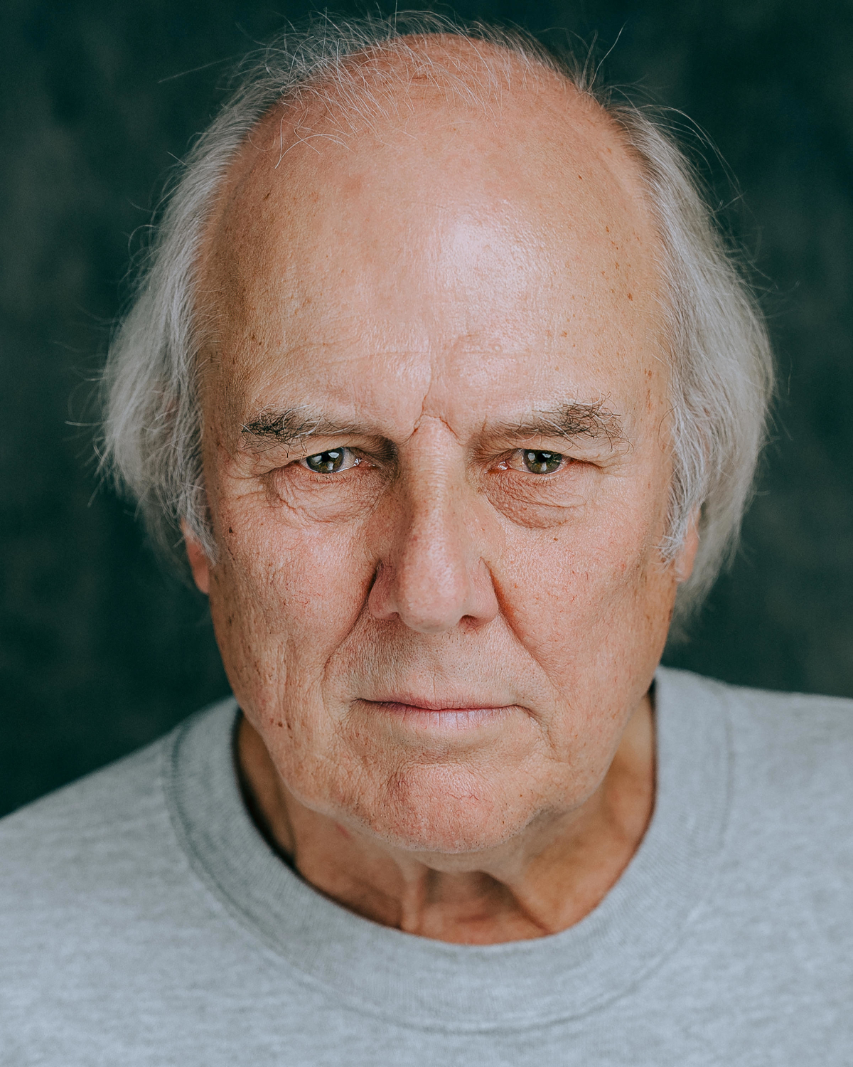 Portrait of white man with medium length hair in his 70's