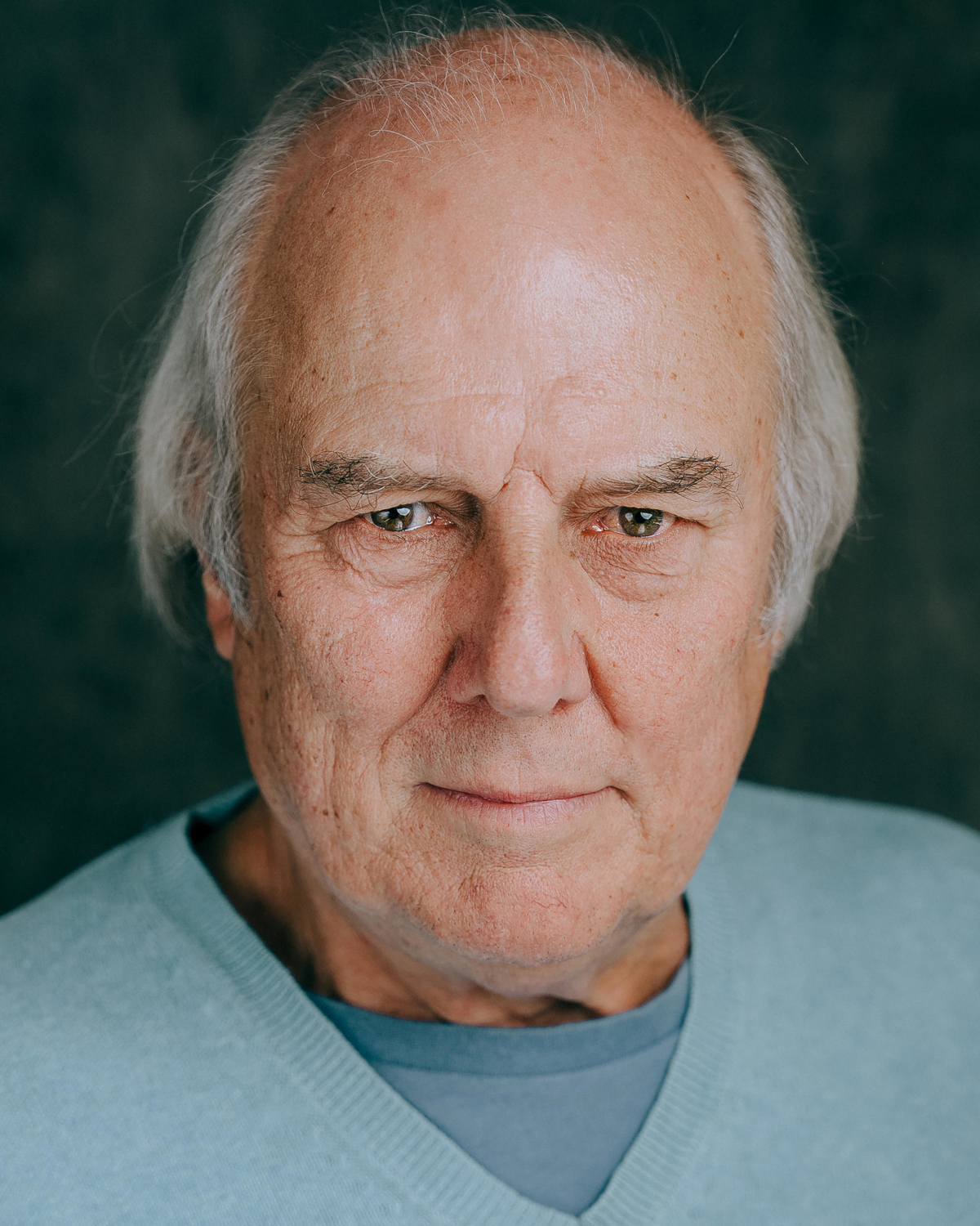 Portrait of white man with medium length hair in his 70's